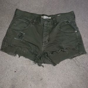 Army green distressed shorts.